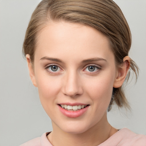 Joyful white young-adult female with medium  brown hair and blue eyes