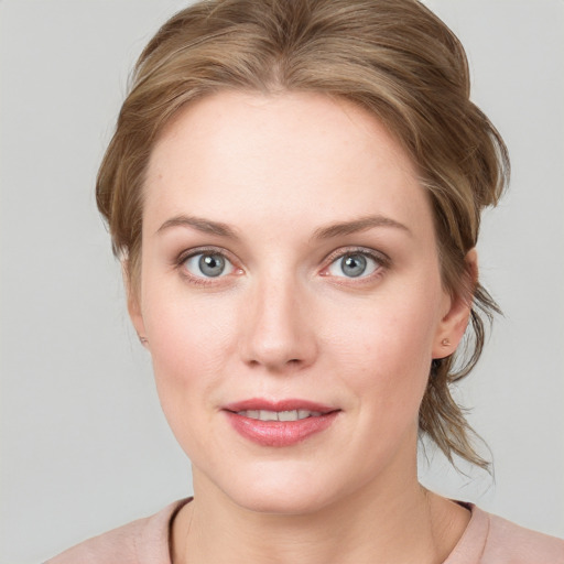 Joyful white young-adult female with medium  brown hair and blue eyes