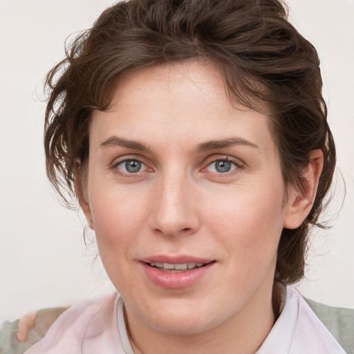 Joyful white young-adult female with medium  brown hair and blue eyes