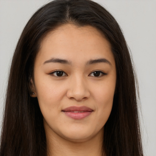 Joyful asian young-adult female with long  brown hair and brown eyes