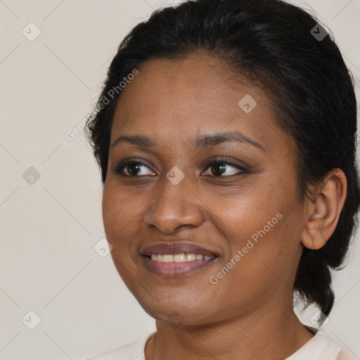 Joyful black young-adult female with medium  brown hair and brown eyes