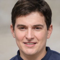 Joyful white adult male with short  brown hair and grey eyes