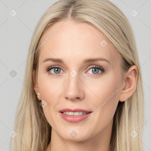 Joyful white young-adult female with long  brown hair and blue eyes