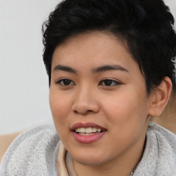 Joyful asian young-adult female with short  black hair and brown eyes