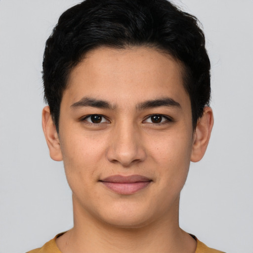 Joyful latino young-adult male with short  black hair and brown eyes