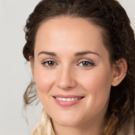 Joyful white young-adult female with long  brown hair and green eyes