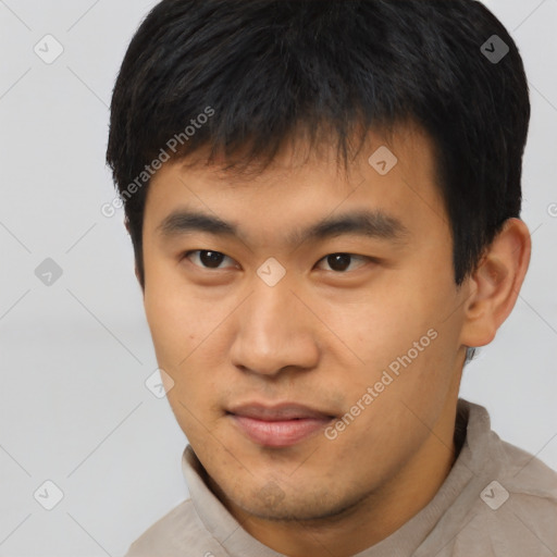 Joyful asian young-adult male with short  brown hair and brown eyes