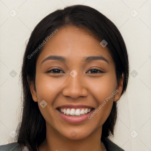 Joyful latino young-adult female with long  black hair and brown eyes