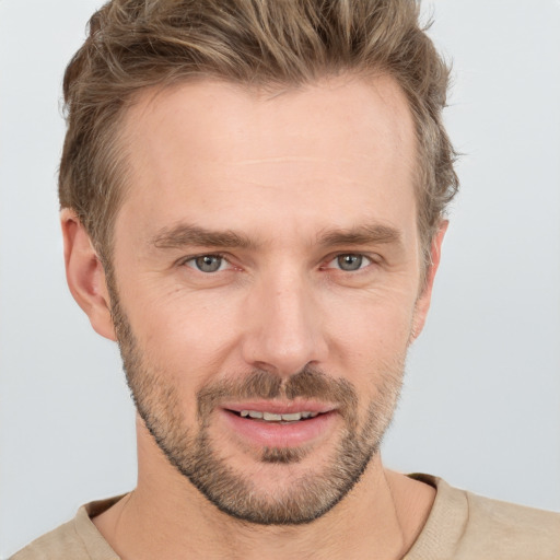 Joyful white adult male with short  brown hair and grey eyes