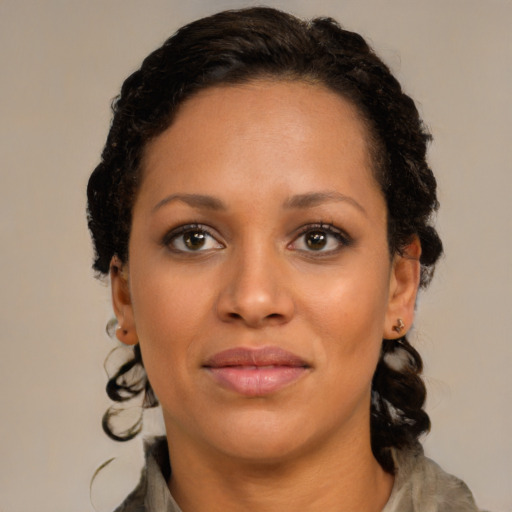 Joyful black young-adult female with medium  brown hair and brown eyes