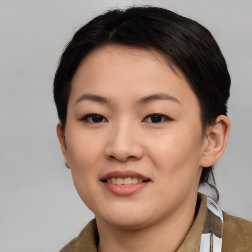 Joyful asian young-adult female with short  brown hair and brown eyes