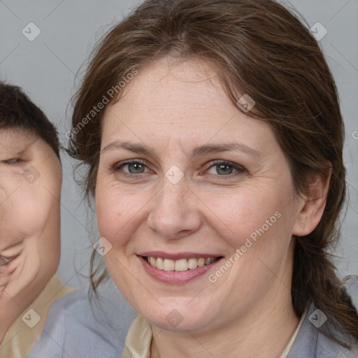 Joyful white adult female with medium  brown hair and brown eyes