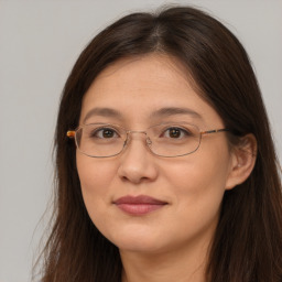 Joyful white adult female with long  brown hair and brown eyes