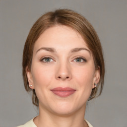 Joyful white young-adult female with medium  brown hair and grey eyes