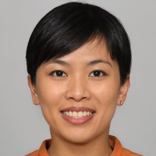 Joyful asian young-adult female with short  black hair and brown eyes