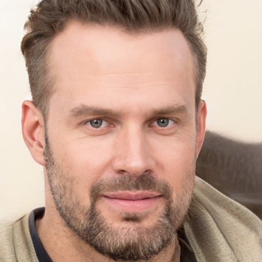 Joyful white adult male with short  brown hair and brown eyes