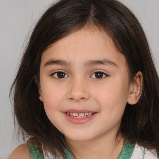 Joyful white child female with medium  brown hair and brown eyes