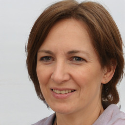 Joyful white adult female with medium  brown hair and brown eyes