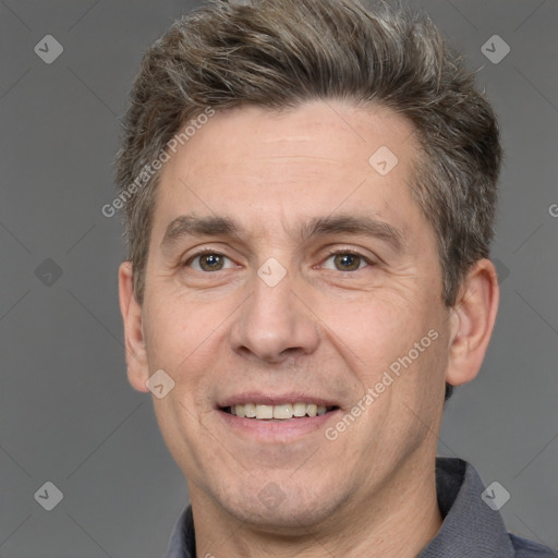 Joyful white adult male with short  brown hair and brown eyes