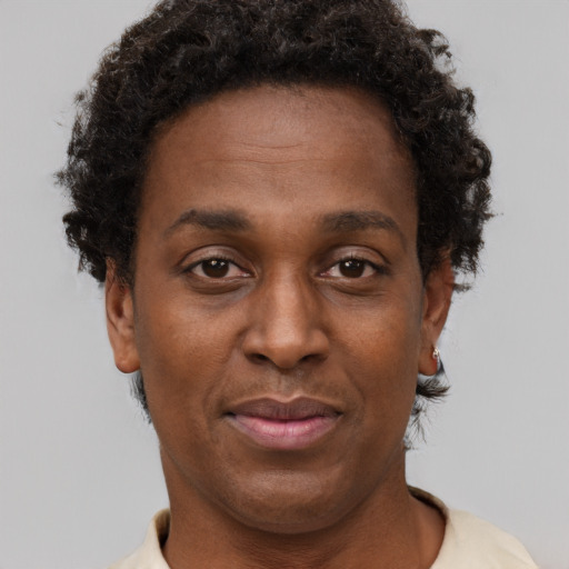 Joyful black adult female with short  brown hair and brown eyes