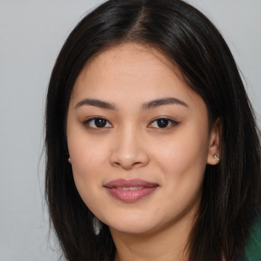 Joyful asian young-adult female with long  brown hair and brown eyes