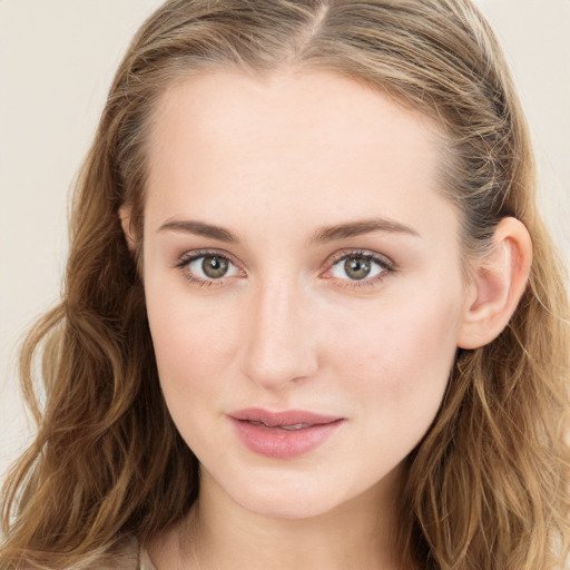 Joyful white young-adult female with long  brown hair and blue eyes