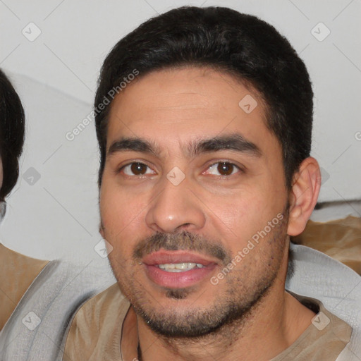 Joyful white young-adult male with short  black hair and brown eyes