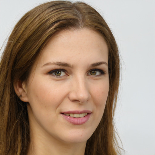 Joyful white young-adult female with long  brown hair and green eyes