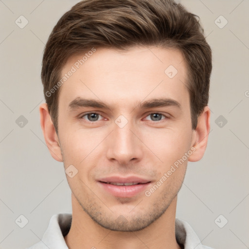 Joyful white young-adult male with short  brown hair and grey eyes