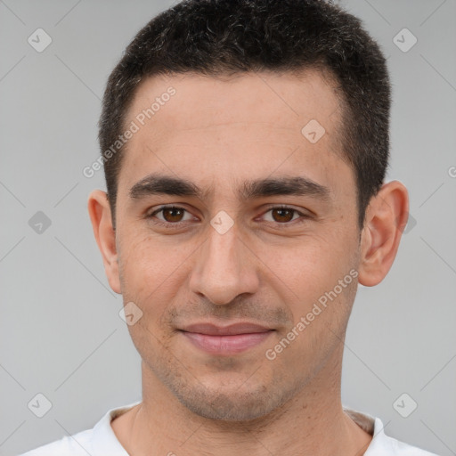 Joyful white young-adult male with short  brown hair and brown eyes