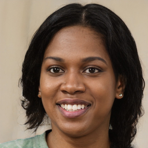 Joyful black young-adult female with medium  black hair and brown eyes
