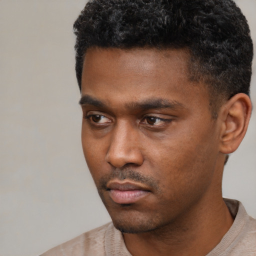 Neutral black young-adult male with short  black hair and brown eyes