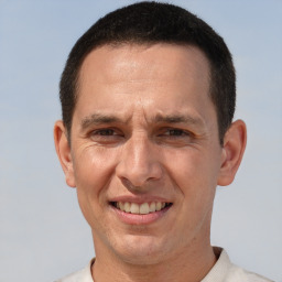 Joyful white adult male with short  brown hair and brown eyes