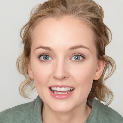 Joyful white young-adult female with medium  brown hair and blue eyes