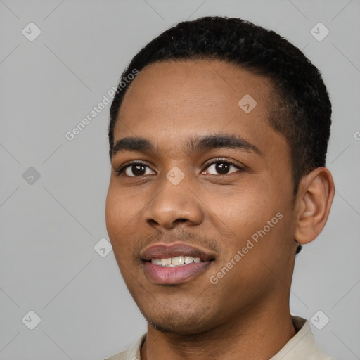 Joyful black young-adult male with short  black hair and brown eyes