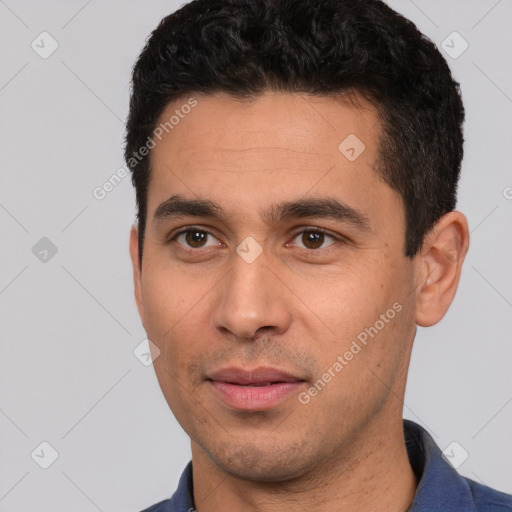 Joyful white young-adult male with short  black hair and brown eyes