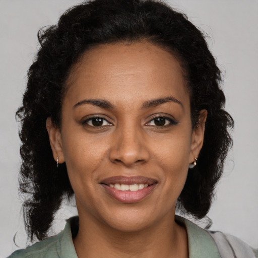 Joyful black young-adult female with medium  brown hair and brown eyes