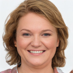 Joyful white adult female with medium  brown hair and blue eyes