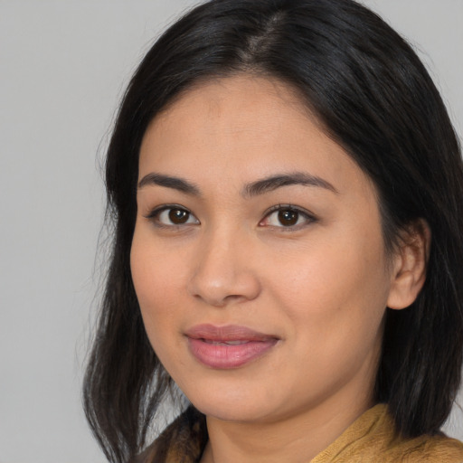 Joyful asian young-adult female with medium  brown hair and brown eyes