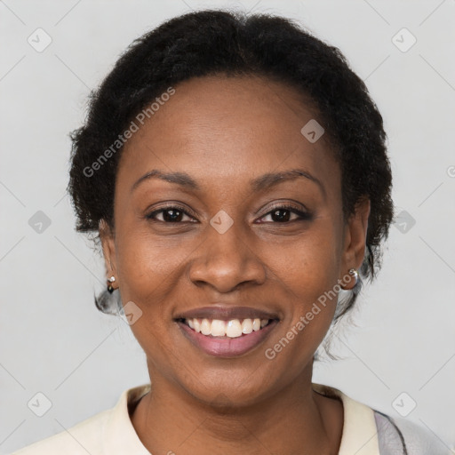 Joyful black young-adult female with short  brown hair and brown eyes