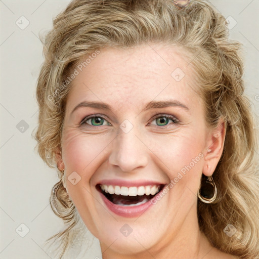 Joyful white young-adult female with long  brown hair and blue eyes