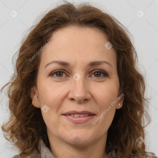 Joyful white adult female with long  brown hair and brown eyes