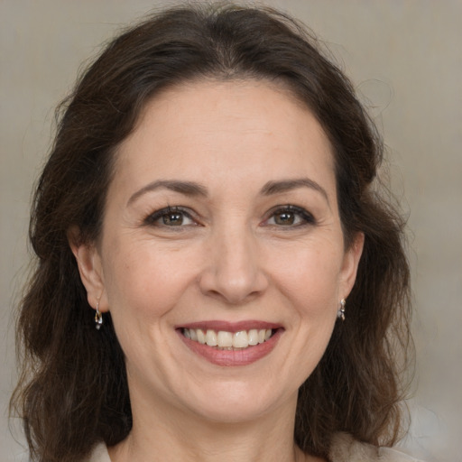 Joyful white adult female with medium  brown hair and brown eyes