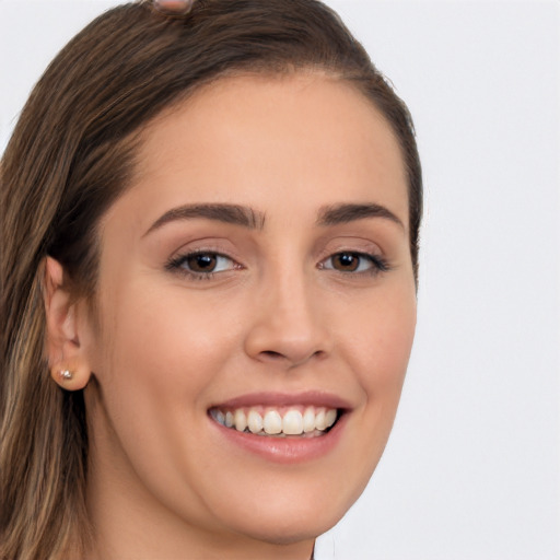 Joyful white young-adult female with long  brown hair and brown eyes