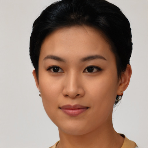 Joyful asian young-adult female with short  black hair and brown eyes