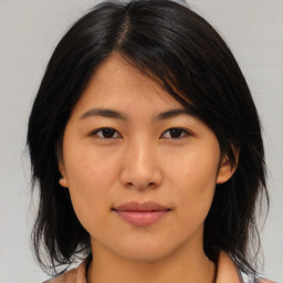 Joyful asian young-adult female with medium  brown hair and brown eyes