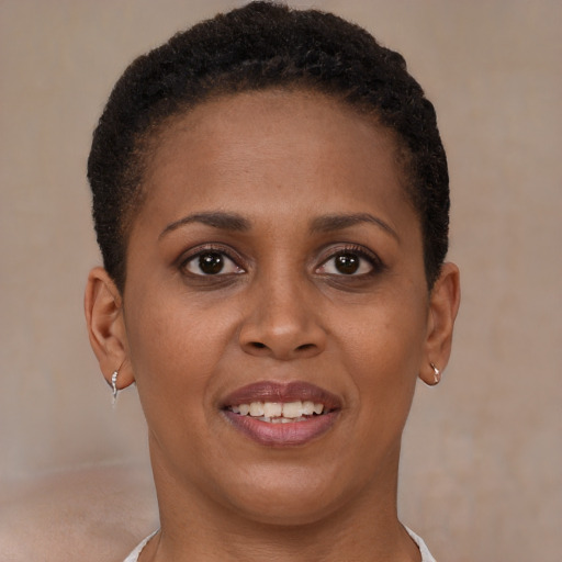 Joyful black young-adult female with short  brown hair and brown eyes