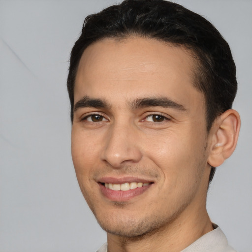 Joyful white young-adult male with short  brown hair and brown eyes