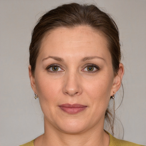 Joyful white adult female with medium  brown hair and grey eyes