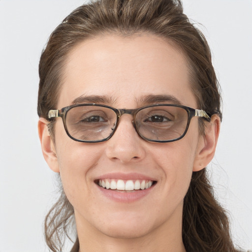 Joyful white young-adult female with medium  brown hair and grey eyes